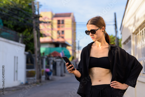 Portrait of young beautiful woman in the city streets outdoors