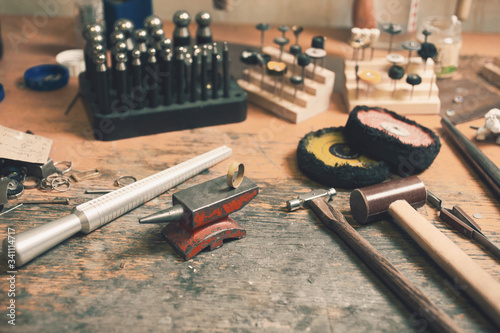 Different goldsmiths tools on the goldsmith workplace. background