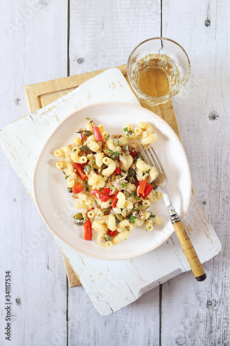 Italian pasta fusilli salad with tuna, bell pepper and cappers photo