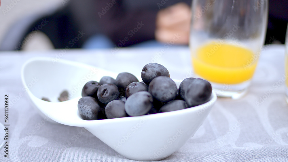 Young woman eats olives in a street restaurant - travel photography Young woman eats olives in a street restaurant - travel photography