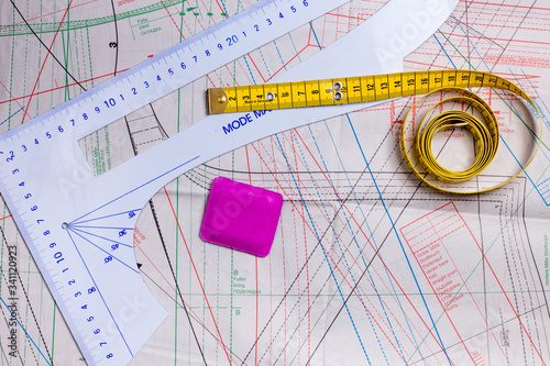 Tape measure, ruler and chalk on a sewing pattern photo