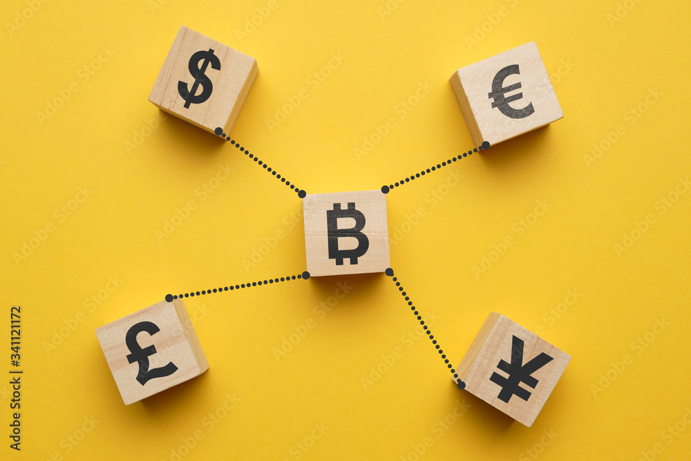 Bitcoin cryptocurrency concept and currency signs - abstract signs on wooden cubes with a yellow background. Bitcoin cryptocurrency concept and currency signs - abstract signs on wooden cubes with a yellow background.