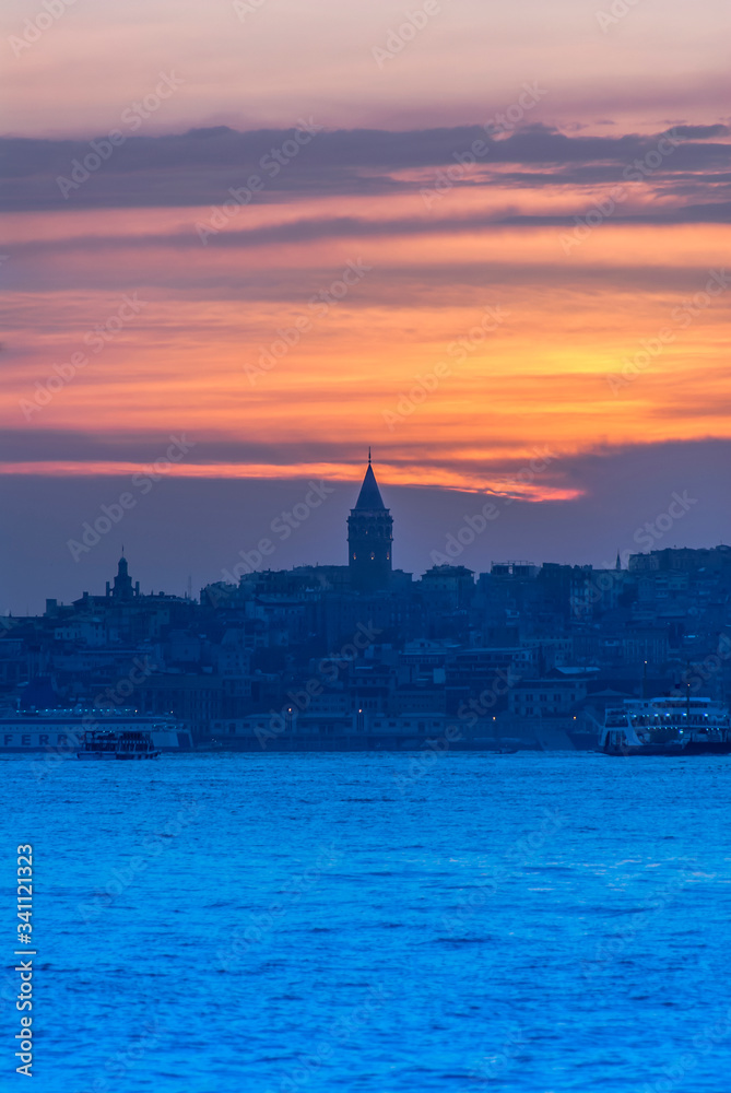 Obraz premium Beyoglu, Istanbul, Turkey, 24 May 2007: Galata Tower, City Lines Ferry, King of Byzantine Anastasius, 528, Sunset.