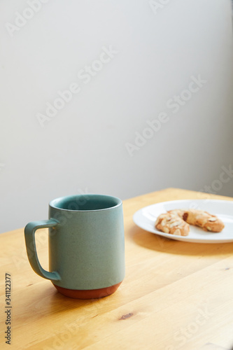 coffee cup with pastry on plate