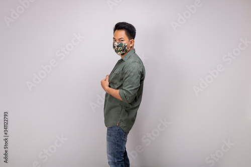 An Asian short hair man wears camouflage mask.