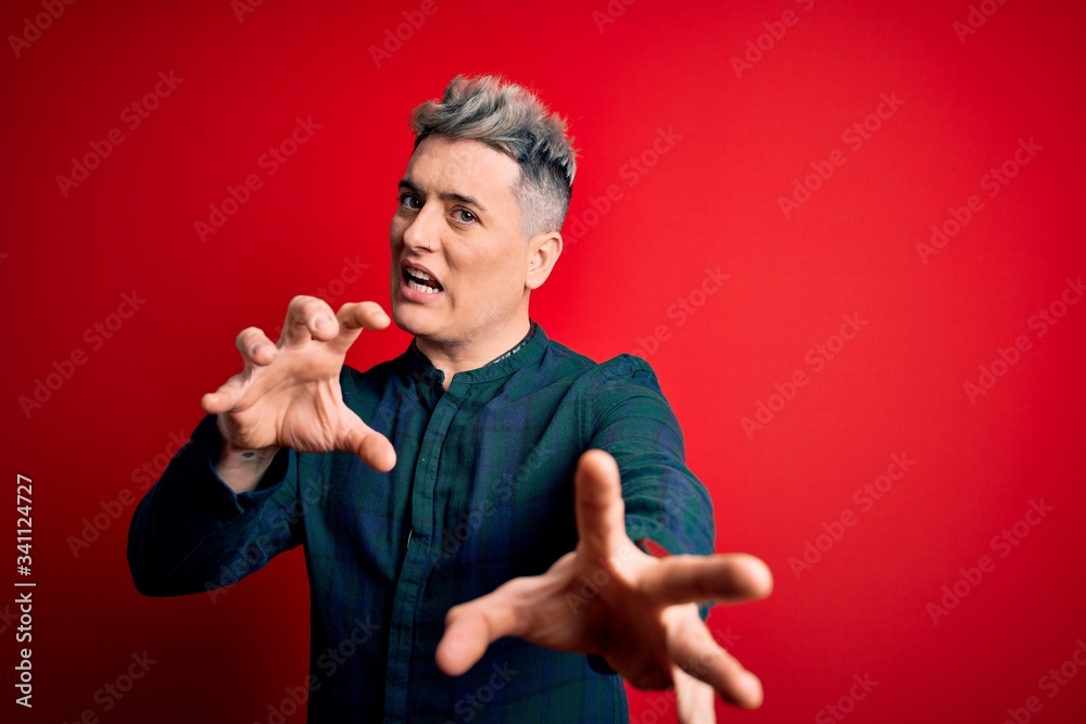 Young handsome modern man wearing elegant green shirt over red isolated background afraid and terrified with fear expression stop gesture with hands, shouting in shock. Panic concept. Young handsome modern man wearing elegant green shirt over red isolated background afraid and terrified with fear expression stop gesture with hands, shouting in shock. Panic concept.