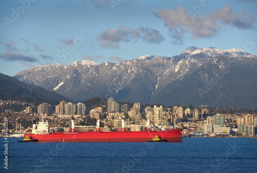 Oil Tanker Burrard Inlet Vancouver. An oil tanker escorted by tug boats in Burrard Inlet. Vancouver, British Columbia, Canada.