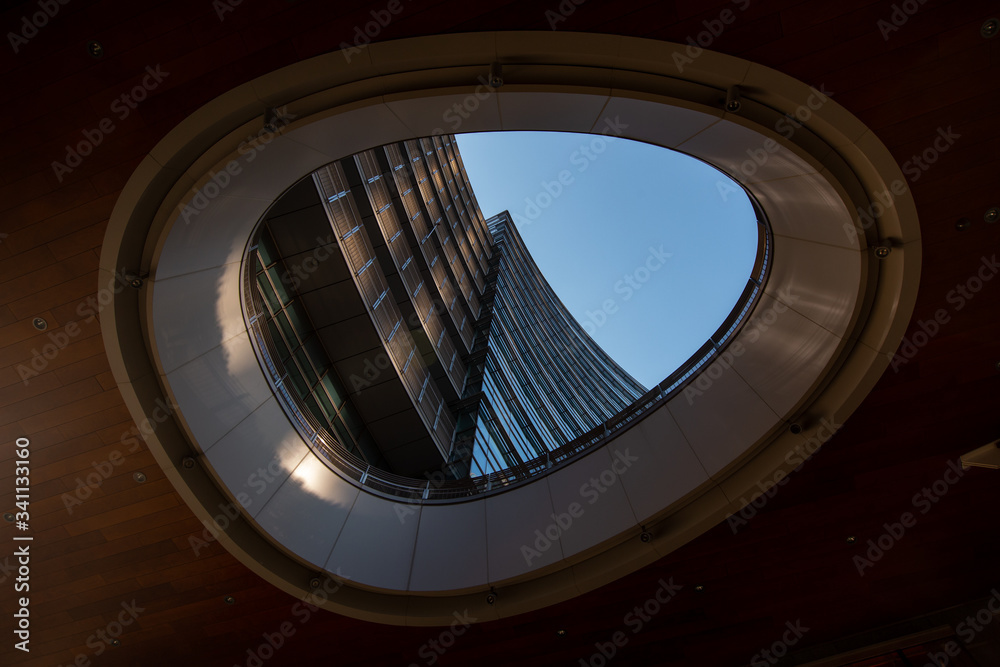 Obraz premium Milan, Italy, March 2020. Window in the window with a view of the multi-storey building. Window color dark wood. Milan 01.20