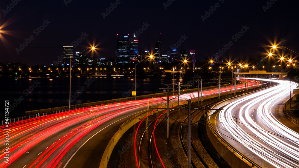 Traffic on highway at night with red and white light trails