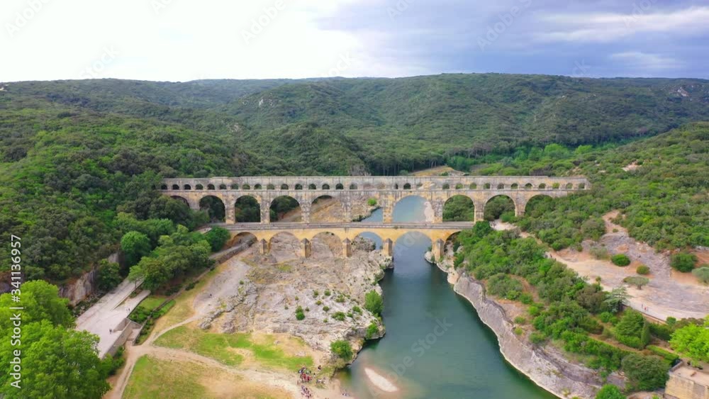 Low altitude aerial of Pont du Gard is an ancient Roman aqueduct that crosses the Gardon River near the town of Vers-Pont-du-Gard in southern France and popular tourist destination 4k Low altitude aerial of Pont du Gard is an ancient Roman aqueduct that crosses the Gardon River near the town of Vers-Pont-du-Gard in southern France and popular tourist destination 4k