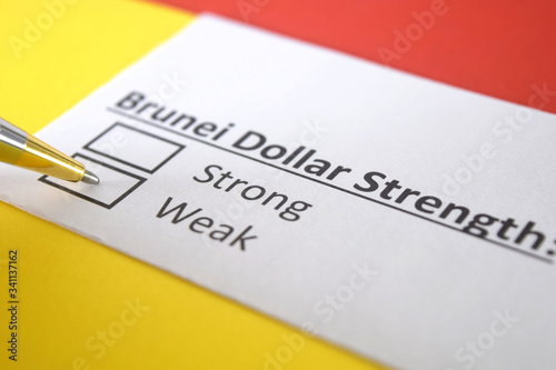 One person is answering question about strength of Brunei Dollar.