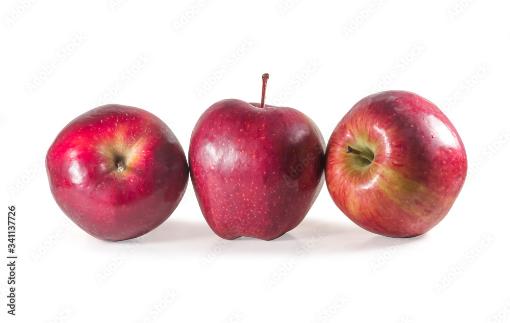 A set of three fresh red apples with drops isolated on white background