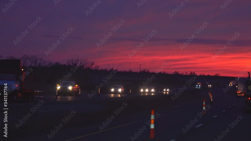 NewYork NY US. 19 April 2019: Car light sunset with busy freeways with other vehicles on the countryside road NewYork NY US. 19 April 2019: Car light sunset with busy freeways with other vehicles on the countryside road