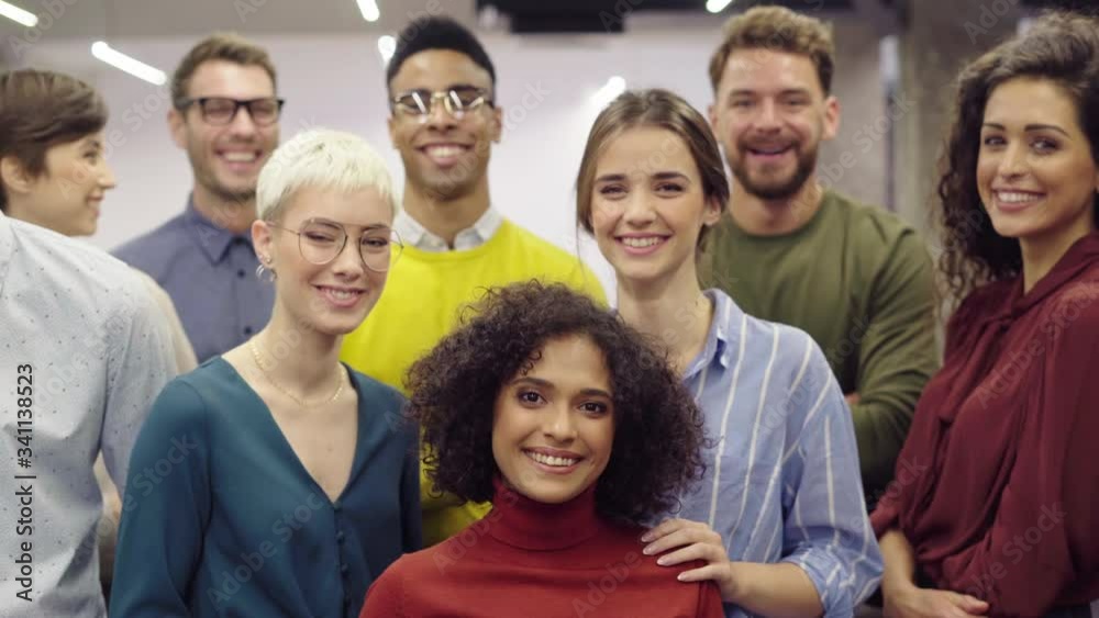 Portrait of successful group of business people at modern office. Happy businessmen and satisfied businesswomen standing together at creative office and looking at camera. Casual multiethnic group. Portrait of successful group of business people at modern office. Happy businessmen and satisfied businesswomen standing together at creative office and looking at camera. Casual multiethnic group.