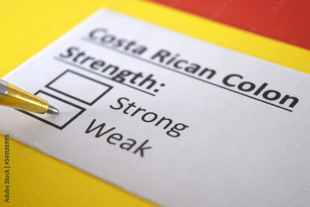 One person is answering question about strength of Costa Rican Colon. One person is answering question about strength of Costa Rican Colon.