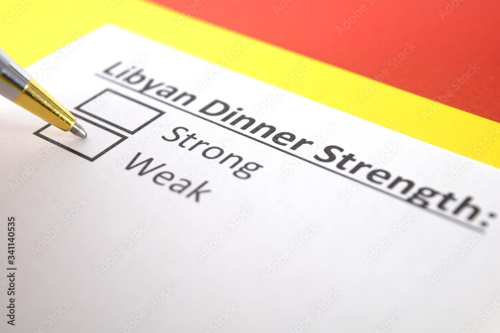 One person is answering question about strength of Libyan Dinner. One person is answering question about strength of Libyan Dinner.