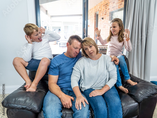 COVID-19 Lockdown. Overwhelmed Parents struggling with stressed kids at home in quarantine