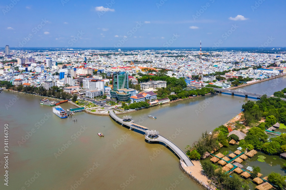 Top view aerial view Love bridge or Ninh Kieu wark bridge Can Tho City, Vietnam with development buildings, transportation, energy power infrastructure.