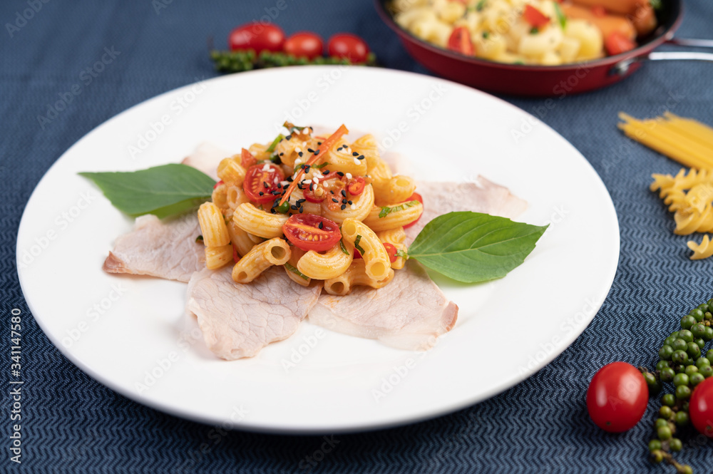 Stir-fry macaroni on top pork roughly in a white plate. Stir-fry macaroni on top pork roughly in a white plate.