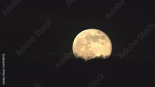 Detailed full moon rising above clouds close up.mov