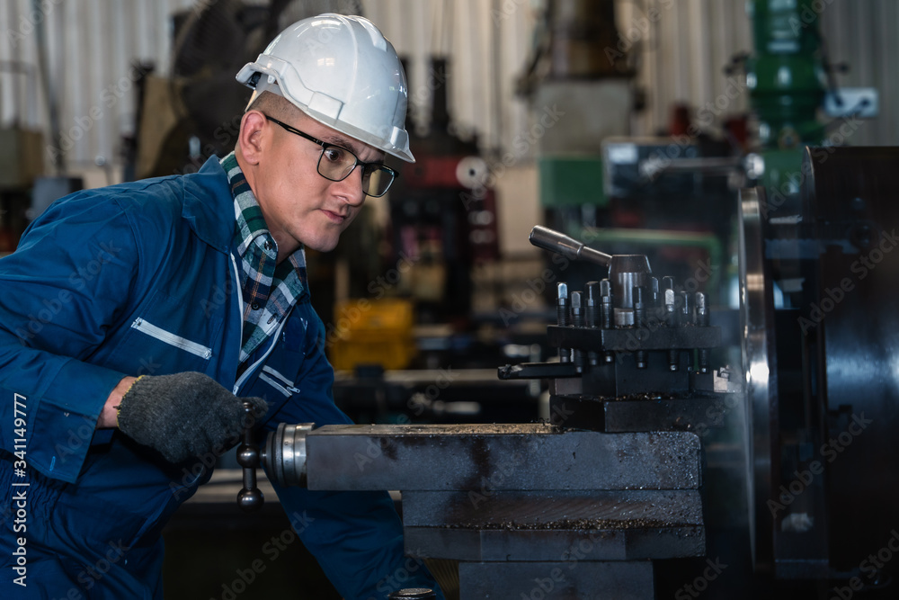 industrial background of caucasian mechanics engineer operating lathe machine to make machine part at metal part manufacturing and workshop factory industrial background of caucasian mechanics engineer operating lathe machine to make machine part at metal part manufacturing and workshop factory