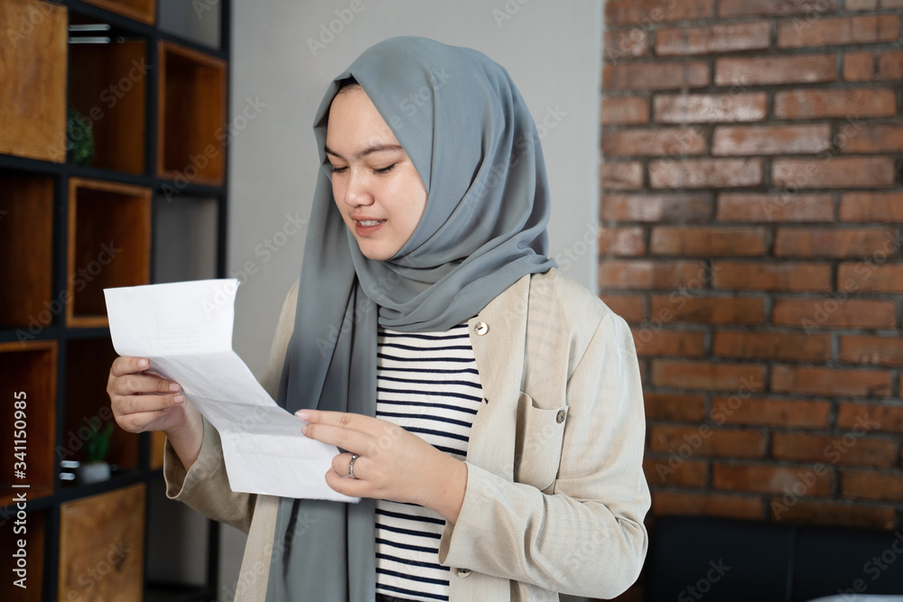 muslim asian woman with hijab looking ticket schedules before go muslim asian woman with hijab looking ticket schedules before go