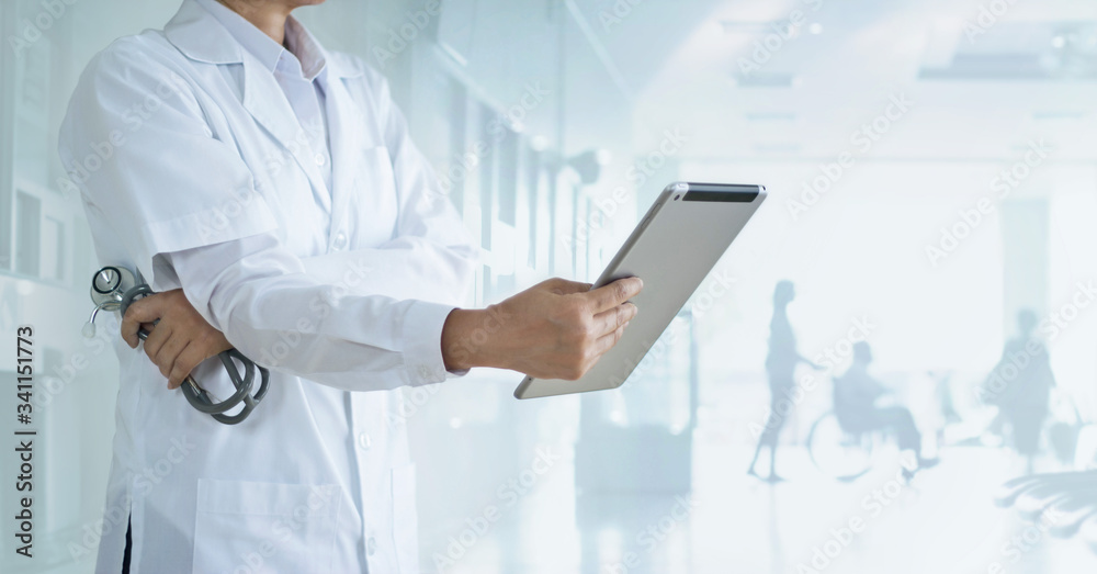 Cardiologist doctor with stethoscope analyzing patient data on tablet in hospital background, Healthcare and medical technology concept. Cardiologist doctor with stethoscope analyzing patient data on tablet in hospital background, Healthcare and medical technology concept.