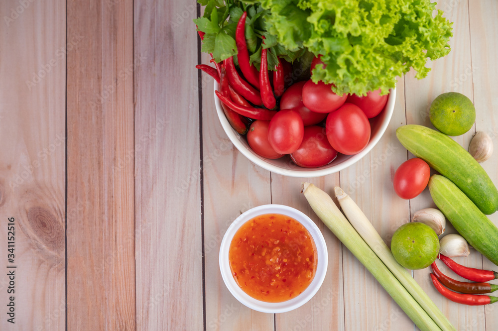 Cucumber, lemon, tomato, garlic, chili with sauce on the wood floor. Cucumber, lemon, tomato, garlic, chili with sauce on the wood floor.