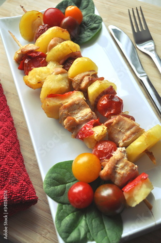 BBQ grilled chicken vegetable kebab skewers ready to eat served on a plate photo