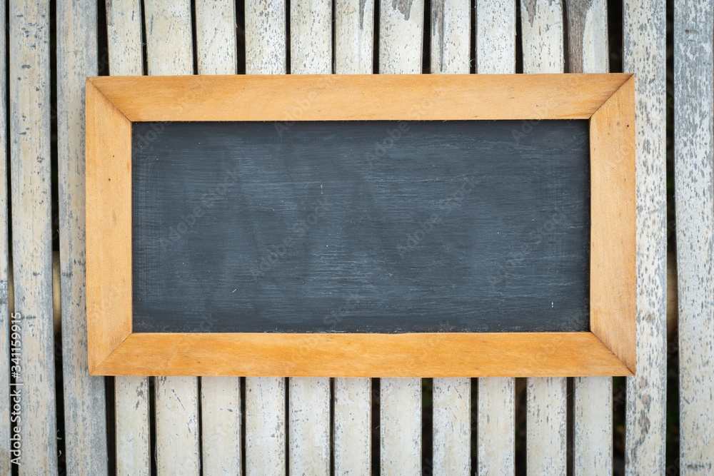 Empty chalk board on bamboo background. Blank blackboard with wooden frame. Empty chalk board on bamboo background. Blank blackboard with wooden frame.