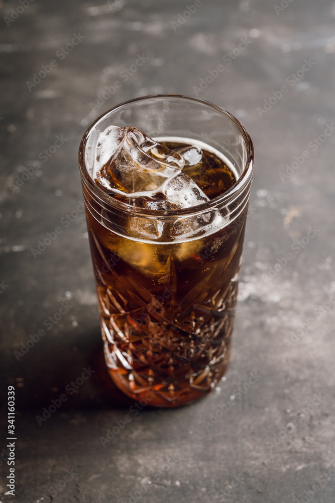 Cold cola beverage in glass with ice. Selective focus. Shallow depth of field. Cold cola beverage in glass with ice. Selective focus. Shallow depth of field.