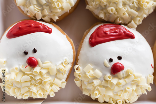 a box of santa claus decorated donuts