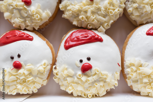a box of santa claus decorated donuts