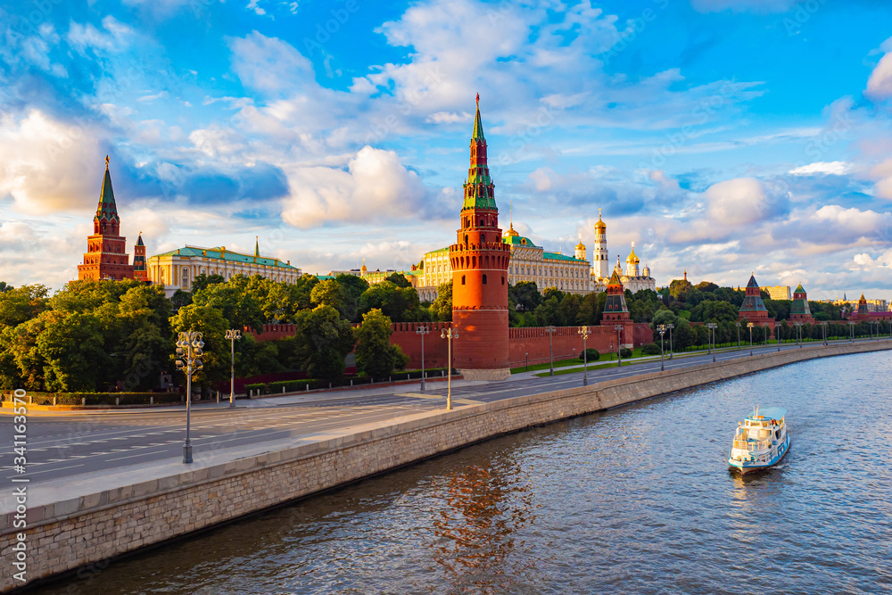Obraz premium Moscow. Russia. View of the Moscow Kremlin from the Moscow river. Red brick towers. Grand Kremlin palace. Water trip to the capital of Russia. Bell Tower Of Ivan The Great.