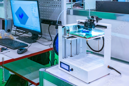 The 3d printer is next to t...