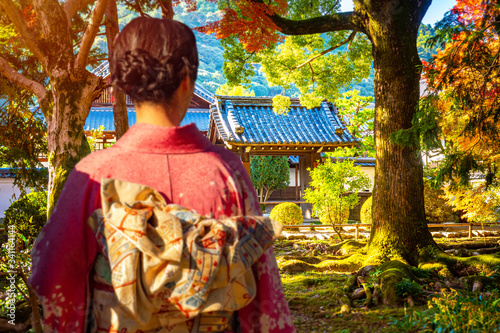 A geisha walks in a Park on...
