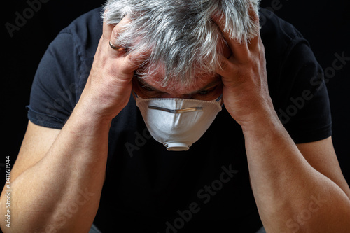 An elderly European man wears a protective mask against the virus. Pandemic Covid-19.