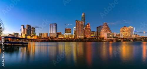 Panorama with downtown view across Lady Bird Lake or Town Lake on Colorado River at sunset golden hour  Austin Texas USA