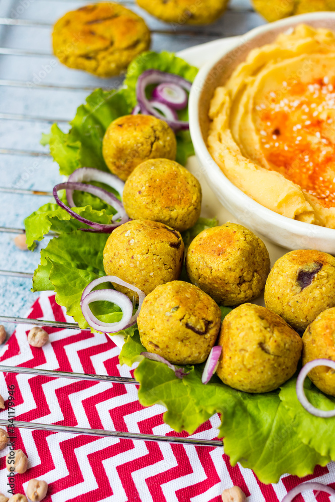 Baked chickpea falafel to eat with hummus, salad leaves and pita bread. Vegan healthy food.