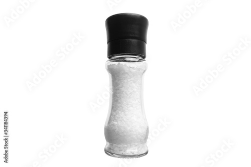 Photos Rock salt in a glass salt cellar isolated on white.