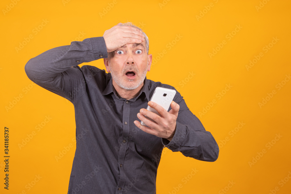 adult or senior man with mobile phone isolated on color background adult or senior man with mobile phone isolated on color background