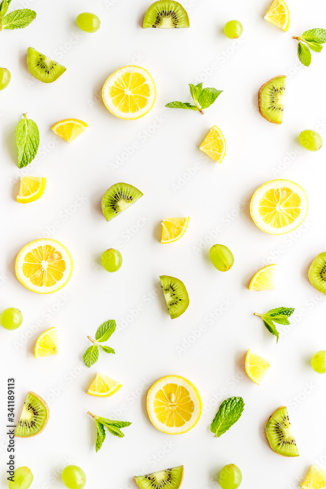 Colorful fruit pattern with citrus and kiwi slices - fresh summer fruits - on white background top-down Colorful fruit pattern with citrus and kiwi slices - fresh summer fruits - on white background top-down