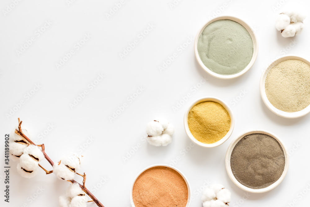 Fototapeta premium cosmetic clay - Yellow, red, white, blue and black - on white background top-down space for text