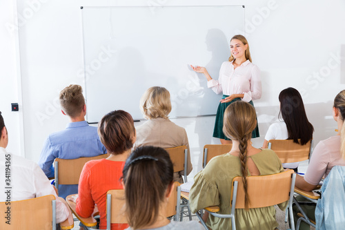 Young female teacher lecturing to students
