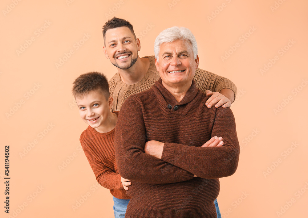 Man with his father and son on color background - obrazy, fototapety, plakaty 