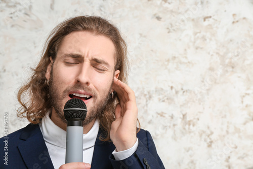 Young male singer on light ...