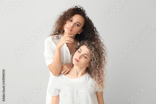 Beautiful young women on light background