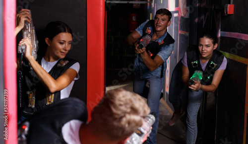 Group of  young people playing laser tag  game with laser guns © JackF