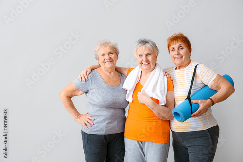 Happy elderly women with yo...