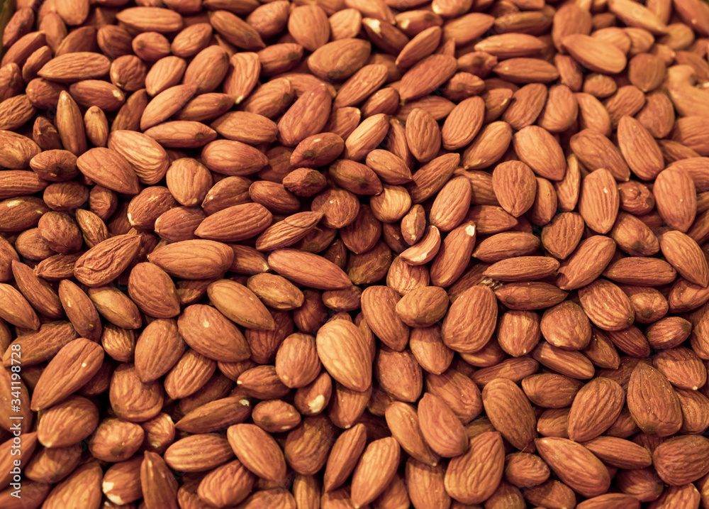 Background made of nuts. Peeled almond bones at the market. Healthy, wholesome food. Organic products. Source of vitamins and minerals. Grocery market in Georgia. Background made of nuts. Peeled almond bones at the market. Healthy, wholesome food. Organic products. Source of vitamins and minerals. Grocery market in Georgia.